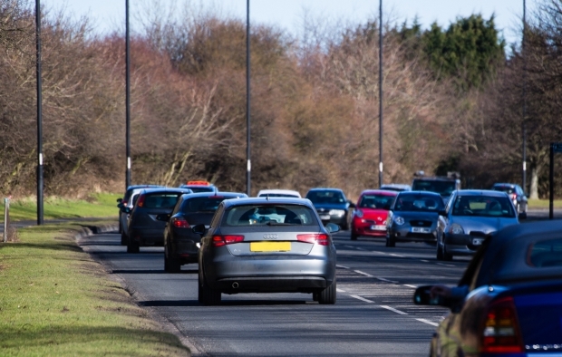 An image of cars driving on a road