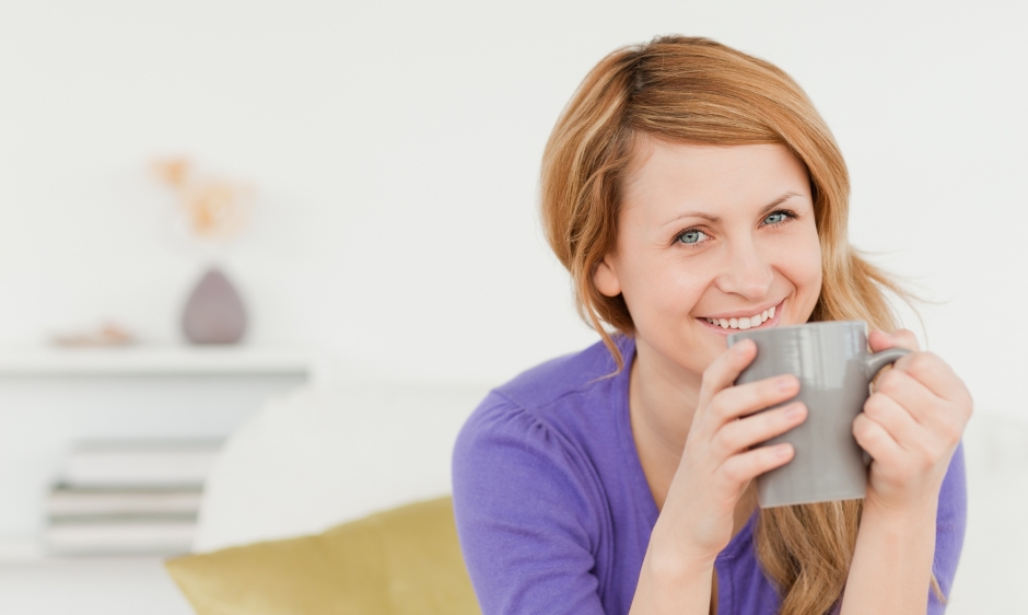 An image of a young woman with a mug