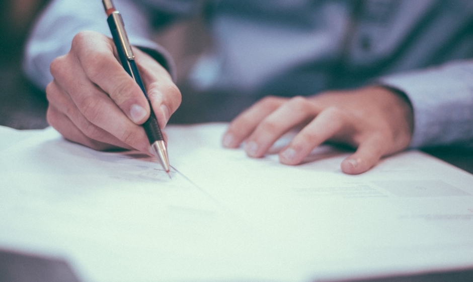 A person signing important documents
