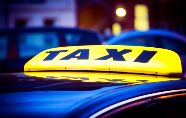 An image of an illuminated taxi sign at night