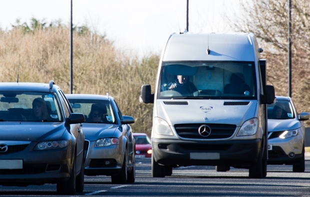 An image of a van driving in traffic