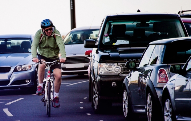 An image of a cyclist riding through traffic
