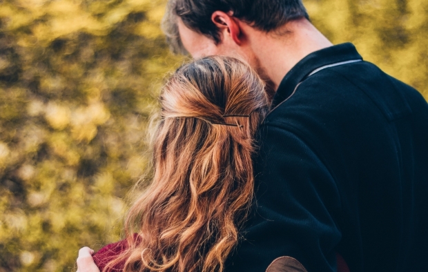A man hugging a woman