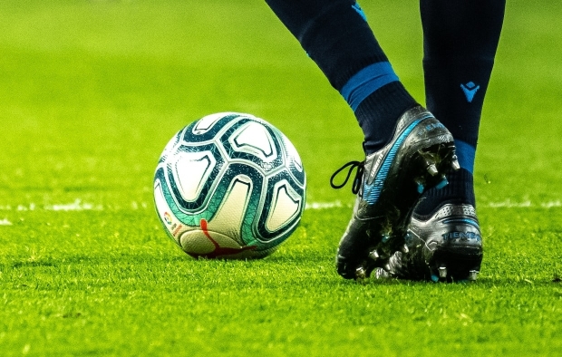 A footballer with the ball at their feet
