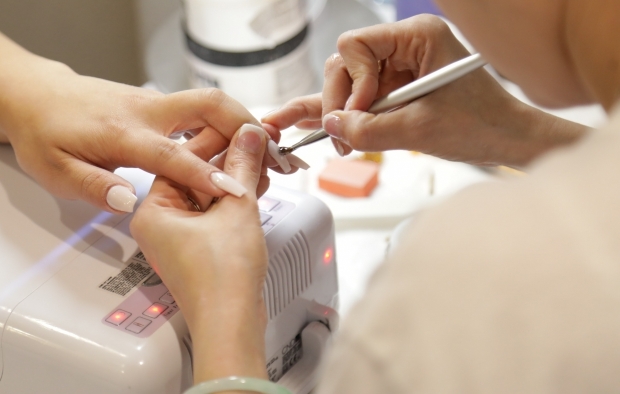 A person having a beauty treatment on their nails