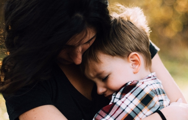 A mother hugs her child