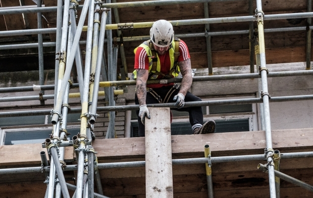 A man works on scaffolding