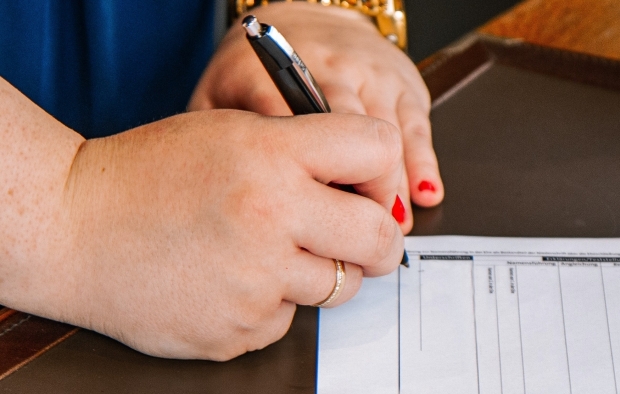 Woman signing a document