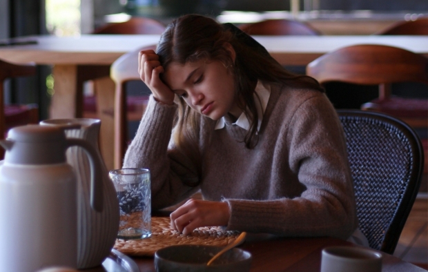 A person thinking about a problem at the table
