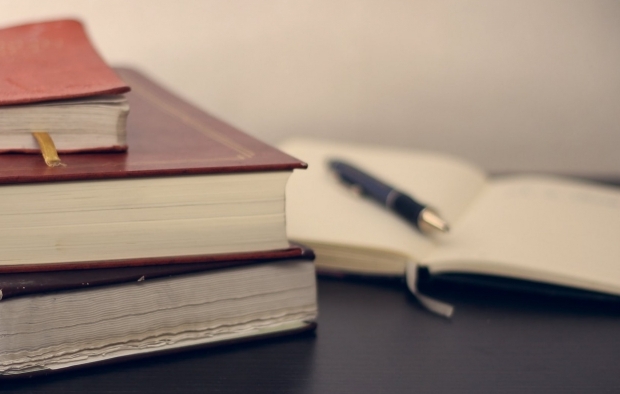 Textbooks open on a desk