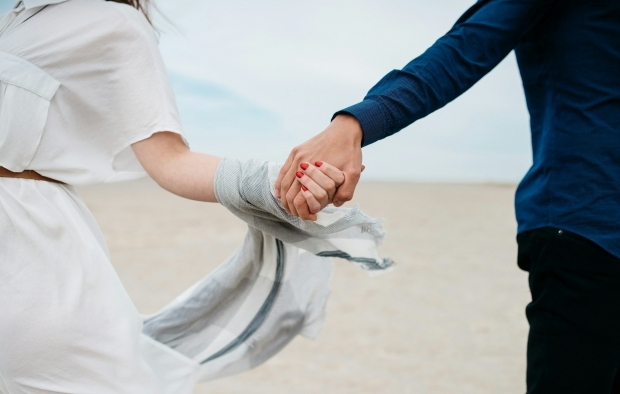 Two people holding hands