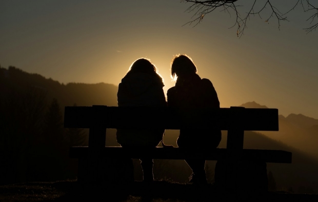 Two people sat on a bench