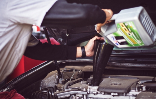 A person repairing their car