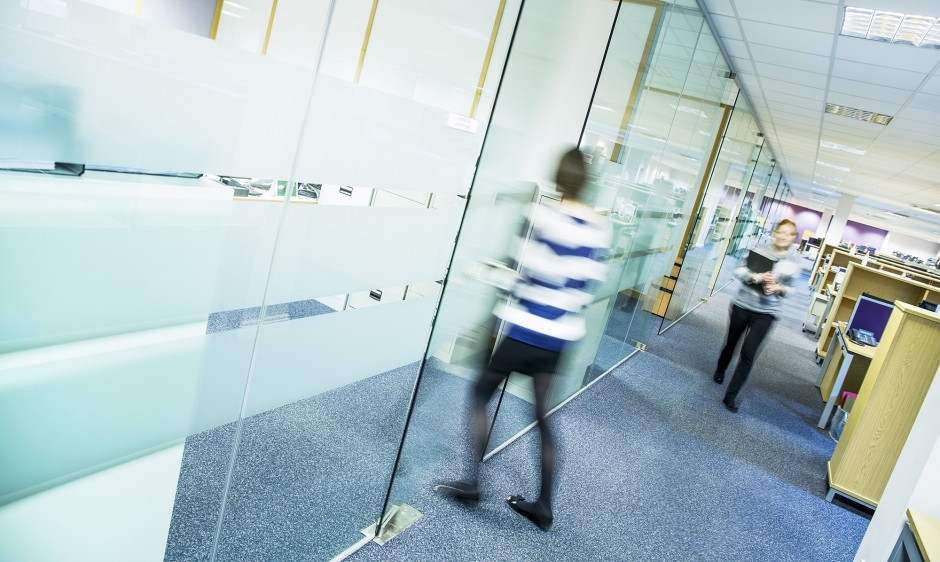 An image of two women walking through an office